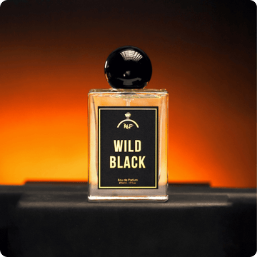 Perfume bottle labeled 'Wild Black' with a black cap on an orange gradient background