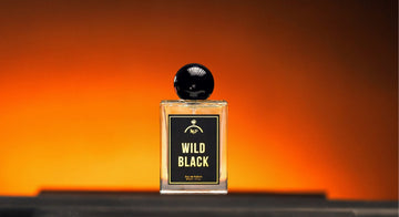 Perfume bottle labeled 'Wild Black' on an orange background
