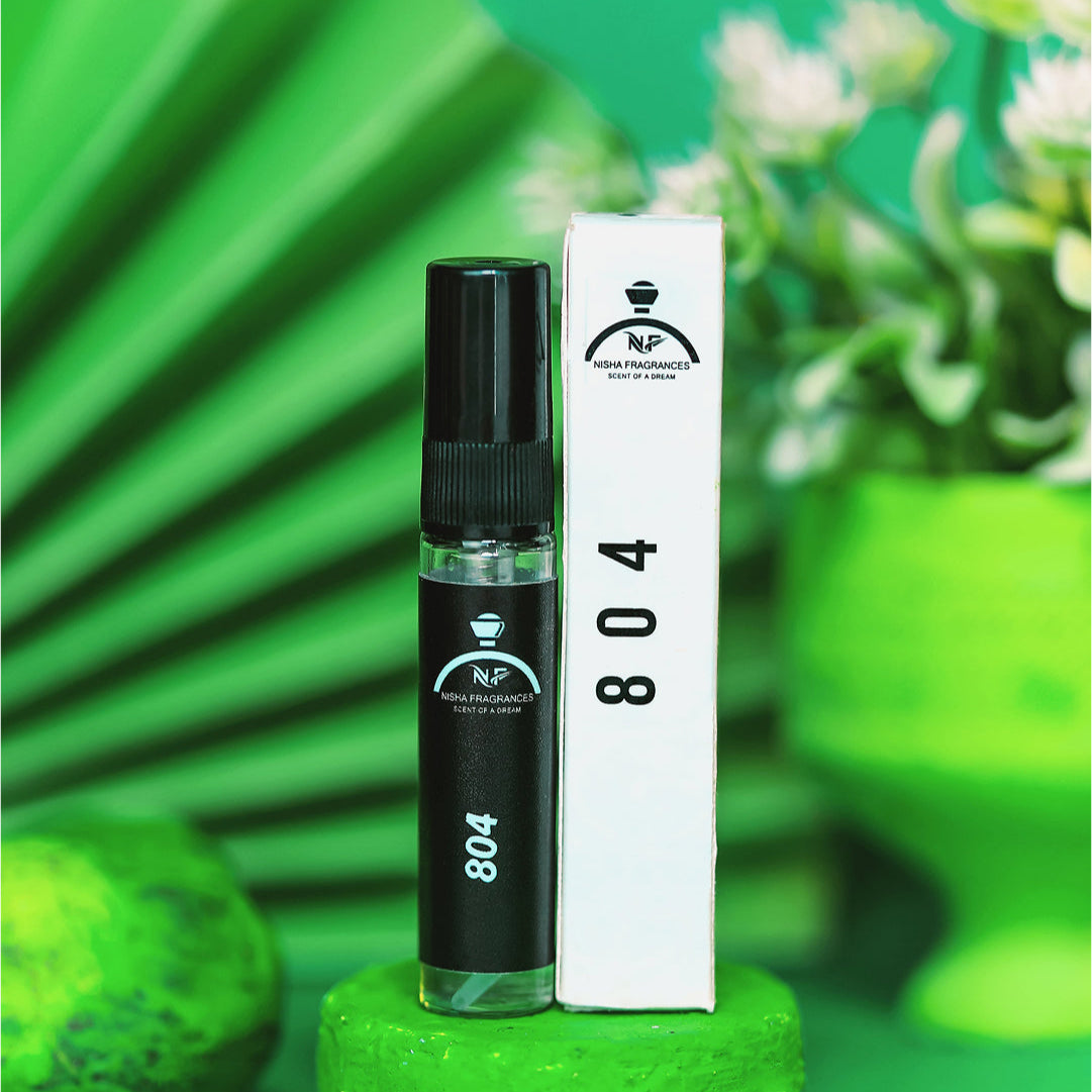Black perfume bottle with white label on a green stand against a green background with decorative elements.