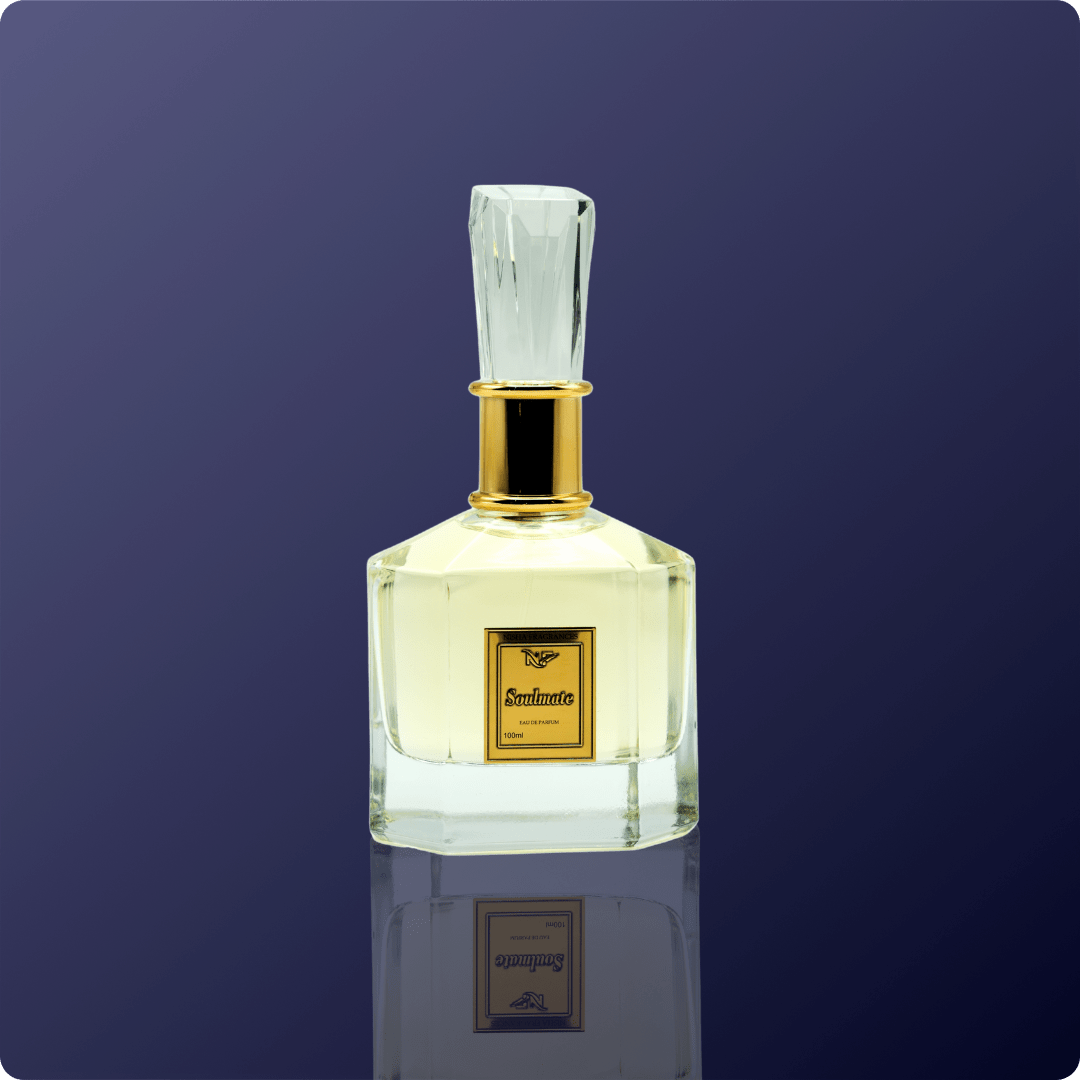 Clear perfume bottle with gold cap on a dark blue background