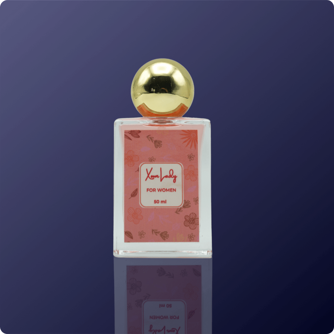 Perfume bottle with gold cap on a reflective surface against a dark blue background