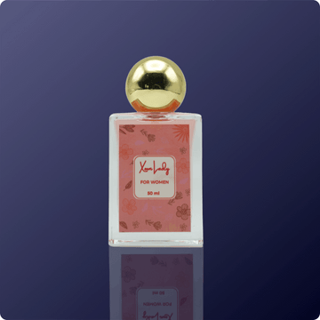 Perfume bottle with gold cap on a reflective surface against a dark blue background