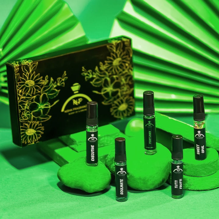 Set of black bottles with green leaves on a green background