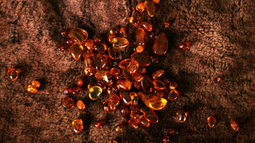 Amber-colored gemstones on a textured brown surface